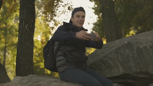 Young Camper Taking Photos of Beautiful Landscape, Enjoying Walk, Green Tourism alt