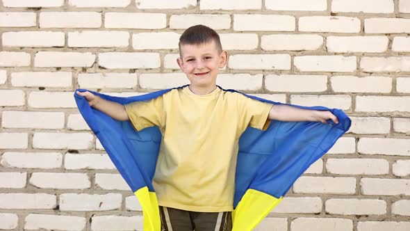 smiling adorable Ukrainian boy is happy with the victory of his country. children against war. 