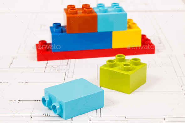 Colorful toy blocks and construction housing plan. Building, buying or renting home concept - Stock Photo - Images
