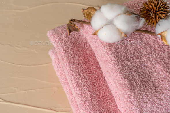 Rolled fluffy towels on shelf in bathroom Stock Photo by FabrikaPhoto