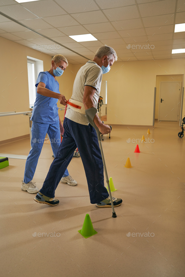 Mature man having physical therapy in rehab center