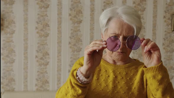 Lovely Old Caucasian Woman Adjusting Sunglasses at Home Medium Closeup Indoor Senior People Concept alt