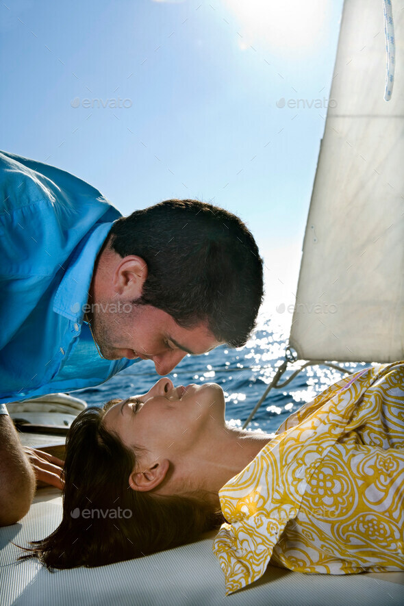 Couple on sailboat, face to face - Stock Photo - Images