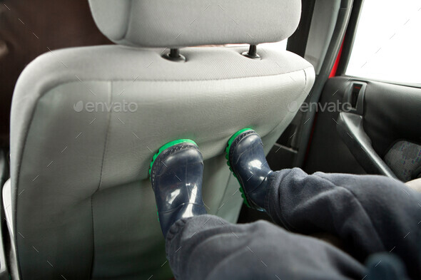 Childs feet on back of car seat