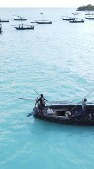 Vertical Video Boats in the Ocean Near the Coast of Zanzibar Tanzania alt