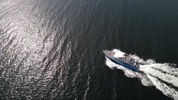 Ariel view of coast guard powerboat cruising in high speed. Speedboat border guard patrol the sea. alt