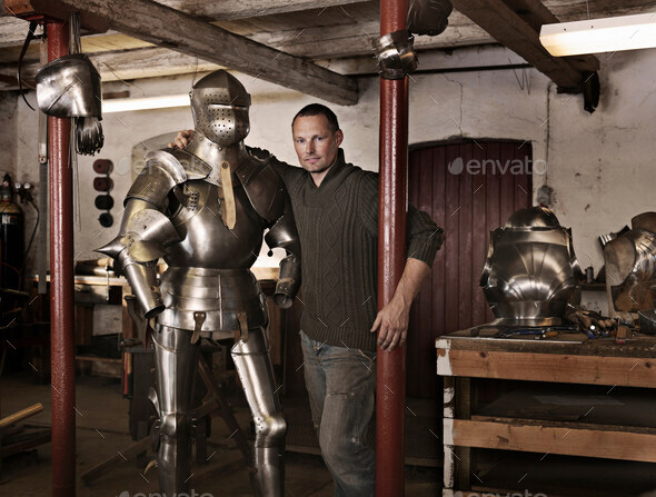 Blacksmith with armor in shop - Stock Photo - Images