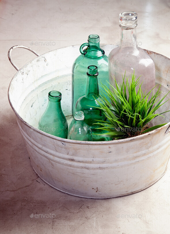 Bottles and plant in an old tub