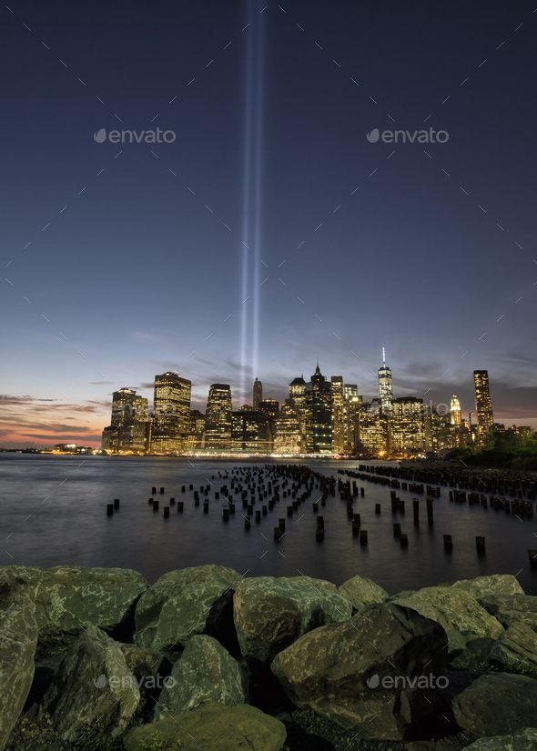 View of light beams over Lower Manhattan from Brooklyn Heights Promenade at night, New York, USA - Stock Photo - Images