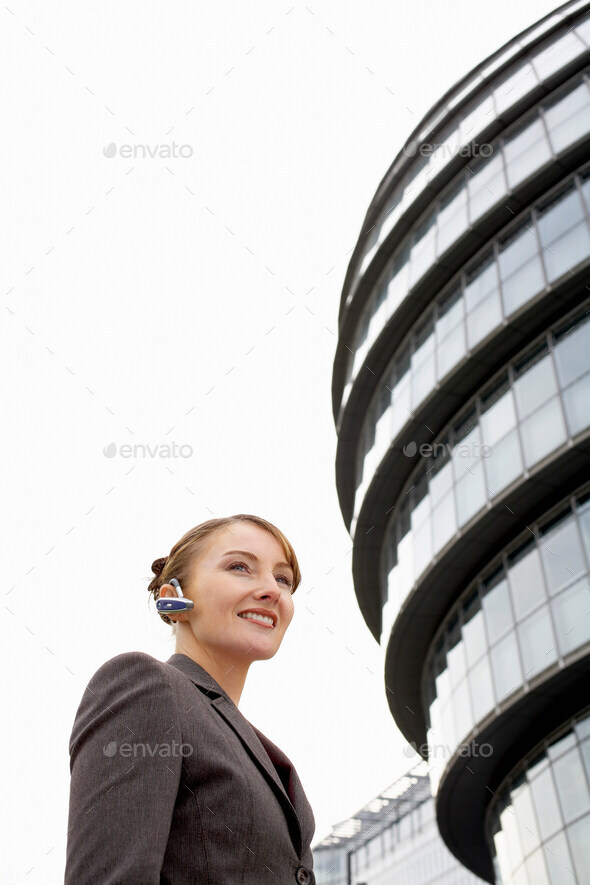 Business woman using bluetooth headset