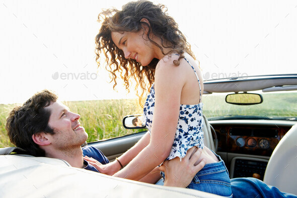 Couple in a convertible - Stock Photo - Images