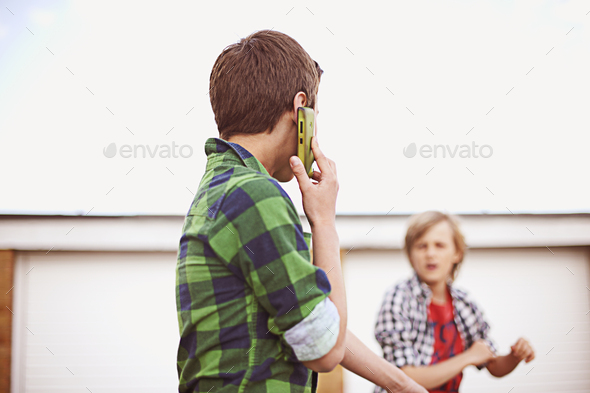 Boy on cell phone - Stock Photo - Images