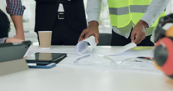 Professional Team of Engineers where One of them Showing Ready Building Plan alt