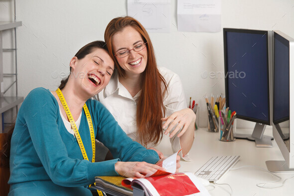 2 women laughing , work environment