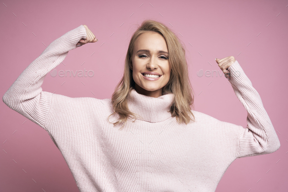 Blonde woman showing success sign - Stock Photo - Images