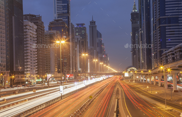 City highway and Dubai metro rail station at night, downtown Dubai, United Arab Emirates - Stock Photo - Images