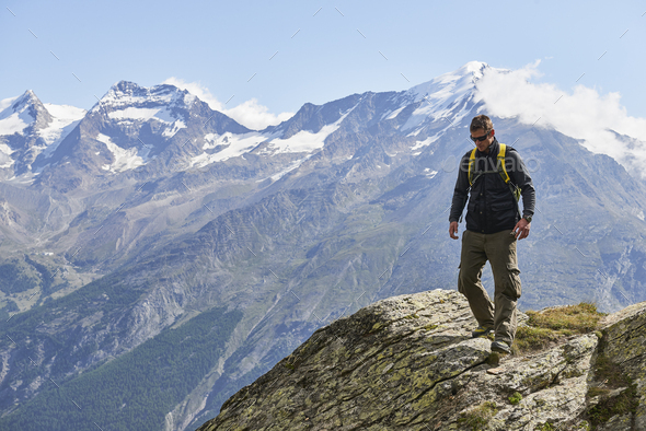 Hiker enjoying walk, Saas-Fee, Valais, Switzerland - Stock Photo - Images