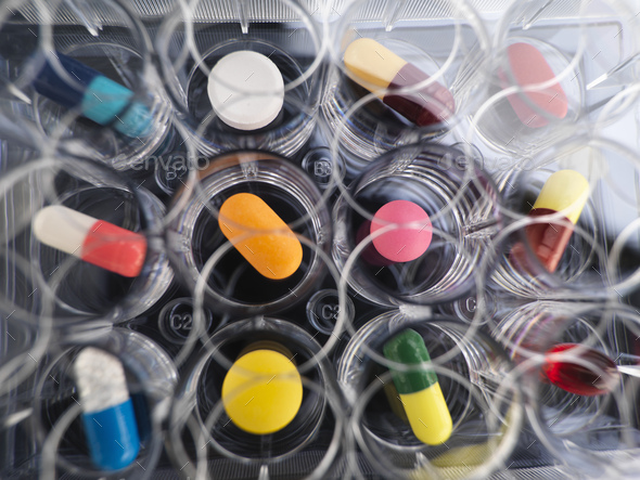 Pharmaceutical research, overhead view of variety of medical drugs in a multi well tray for