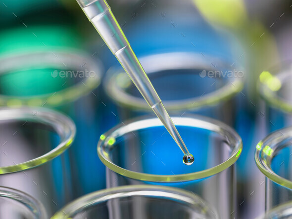 Analytical chemistry - sample being pipetted into test tube for analysis in laboratory
