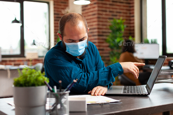 Businessman wearing medical protective face mask to prevent infection with coronavirus