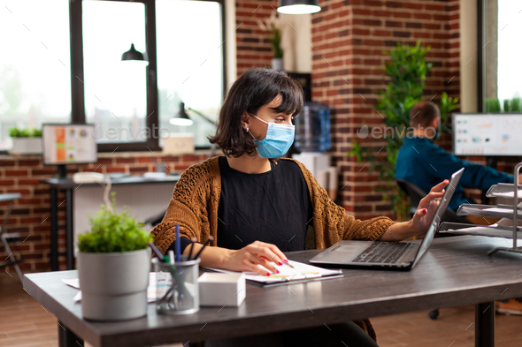 Businesswoman with medical protective face mask against coronavirus