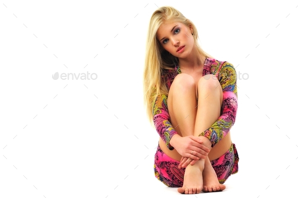 A girl in a dress. In a studio. With beautiful long legs Stock