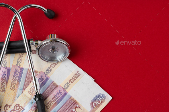 Pile of Russian Rubles with medical stethoscope. Medical expenses concept
