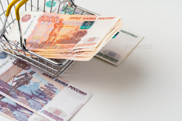 Toy shopping cart with Russian rubles money. Living wage and purchasing power concept - Stock Photo - Images