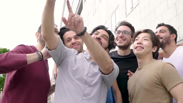 Slow motion shot of happy group of best friends taking a selfie