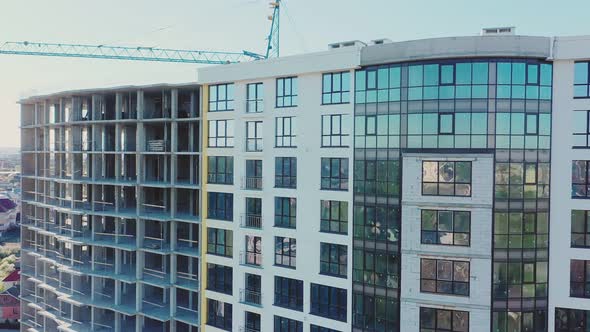 Many windows on new apartment building facade under construction. Real estate development alt