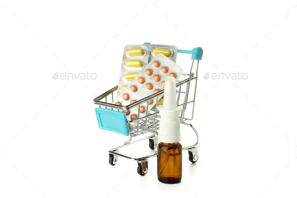 Nasal spray and shop trolley with pills isolated on white background