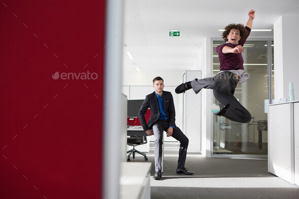 Office worker jumping in mid air
