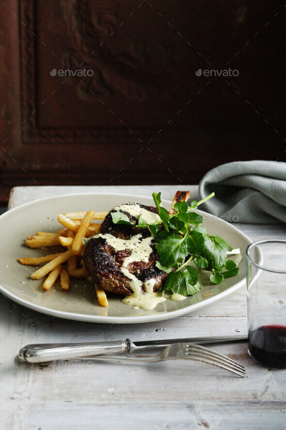 Plate of steak with fries and salad
