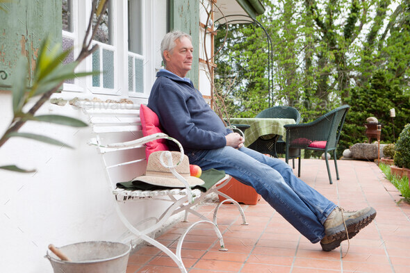 Older man sitting on porch