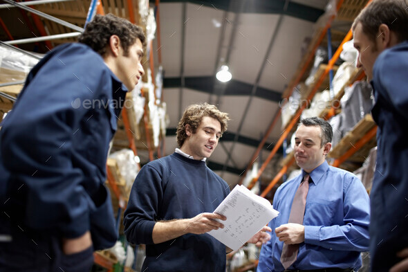 Manager and workers in warehouse - Stock Photo - Images