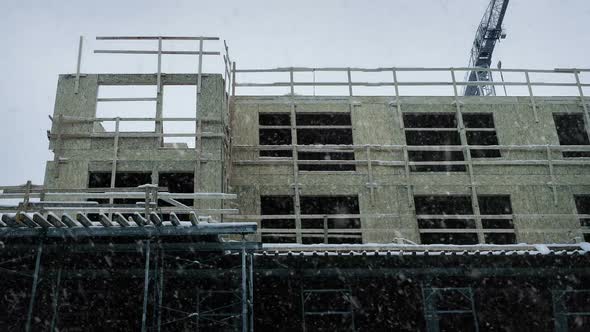 Large Building Under Construction In Snowfall alt