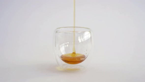 Honey in clear glass bowl isolated on white background. Sweet. Food. Honey bees. alt