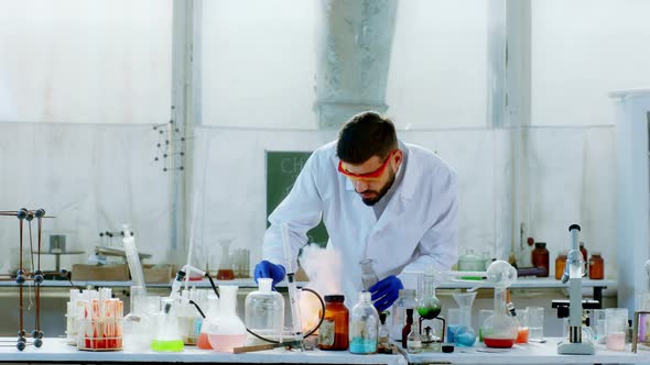 Lab Expert Man Adding Some Chemical Reaction on alt