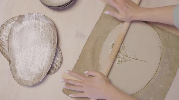 Artisan Making Flower Print on Clay alt