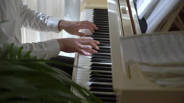 Pianist Plays Music on White Piano