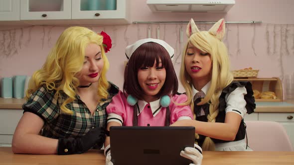 Cheerful Multiracial Women Cosplayers with Tablet Pc Video Conferencing Online alt