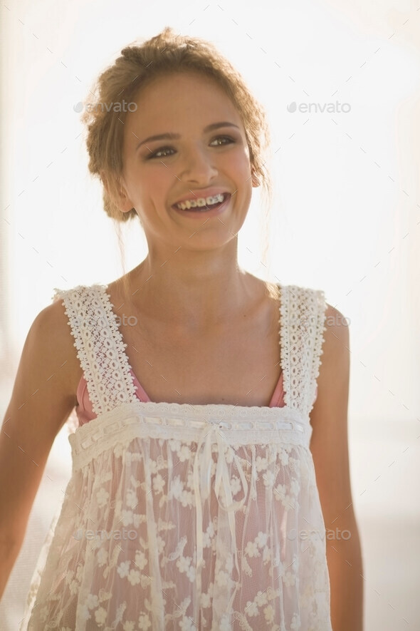Smiling teenage girl wearing sheer dress