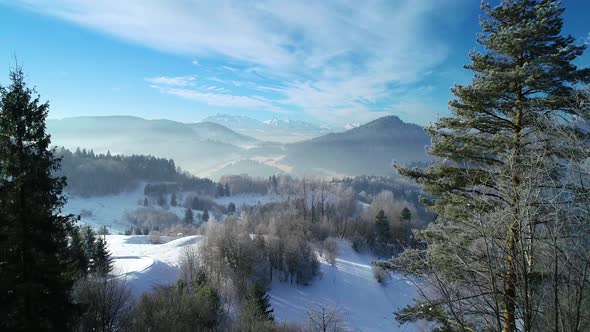 Aerial view of beautiful winter white scenery in mountains. Ski resort in alpine winterland