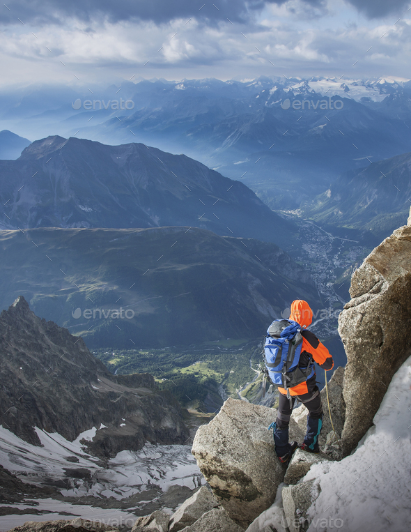 Mountain climber descending the Dent du Geant, in the Mont Blanc Massif, Courmayeur, Aosta Valley,