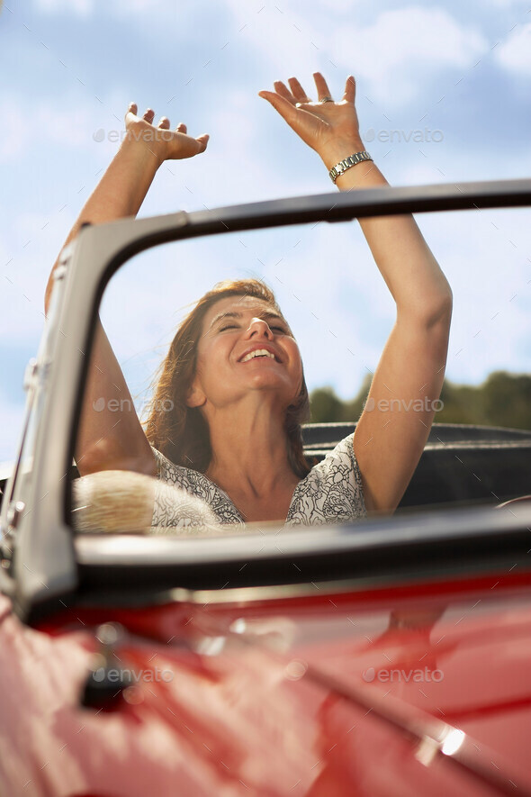 Mid aged woman in sports car