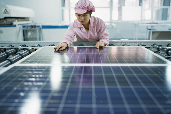 Female worker in solar panel assembly factory, Solar Valley, Dezhou, China
