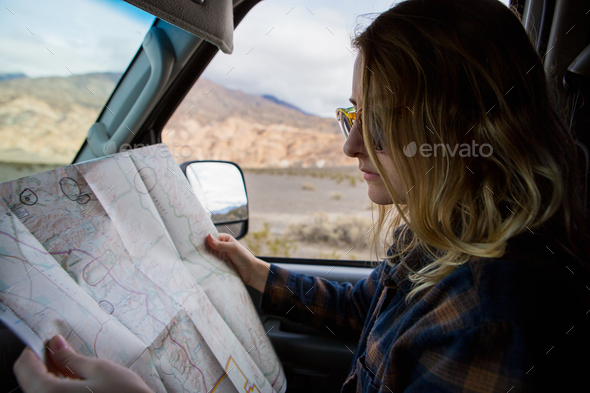 Woman reading map in car, Death Valley National Park, California, US