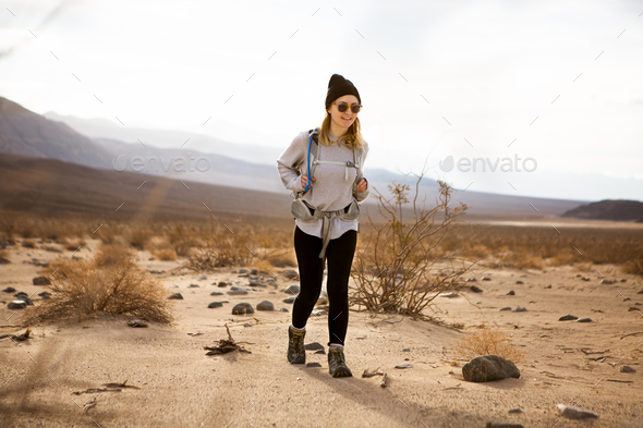 Trekker running in Death Valley National Park, California, US