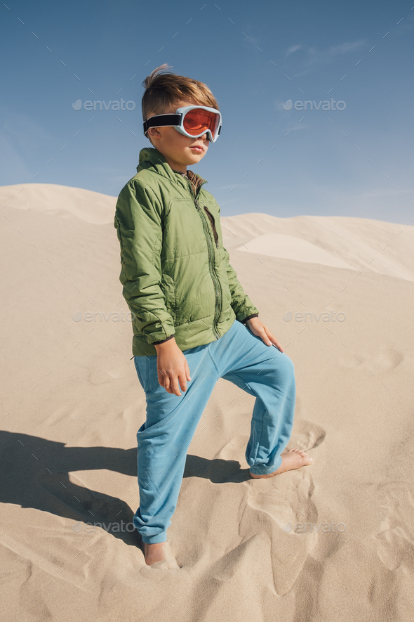 Portrait of boy on sand dunes, wearing goggles, Eureka Dunes, Death Valley National Park, California