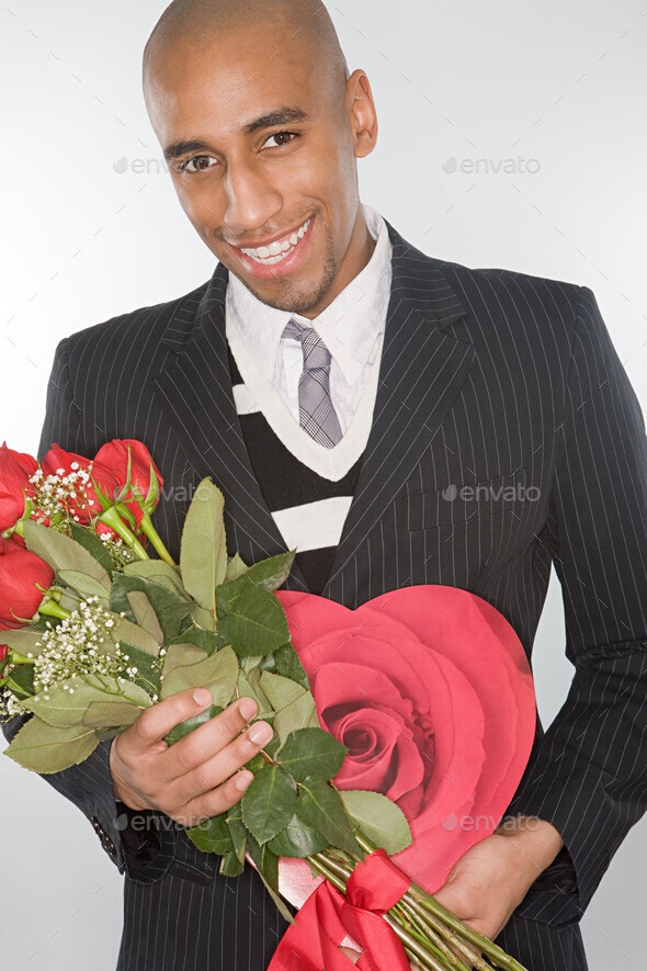 Smiling man holding a bunch of roses - Stock Photo - Images